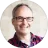 Man wearing eyeglasses and red polo shirt.